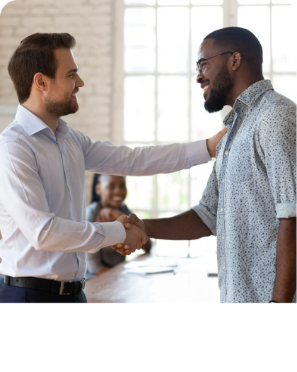 men shaking hands and smiling, presumably closing a flooring deal