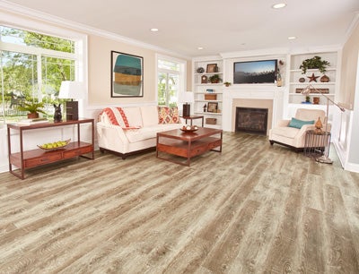 Vinyl combines the appealing look of wood, stone or tile in your living room or family room space with a more comfortable feel and an affordable price