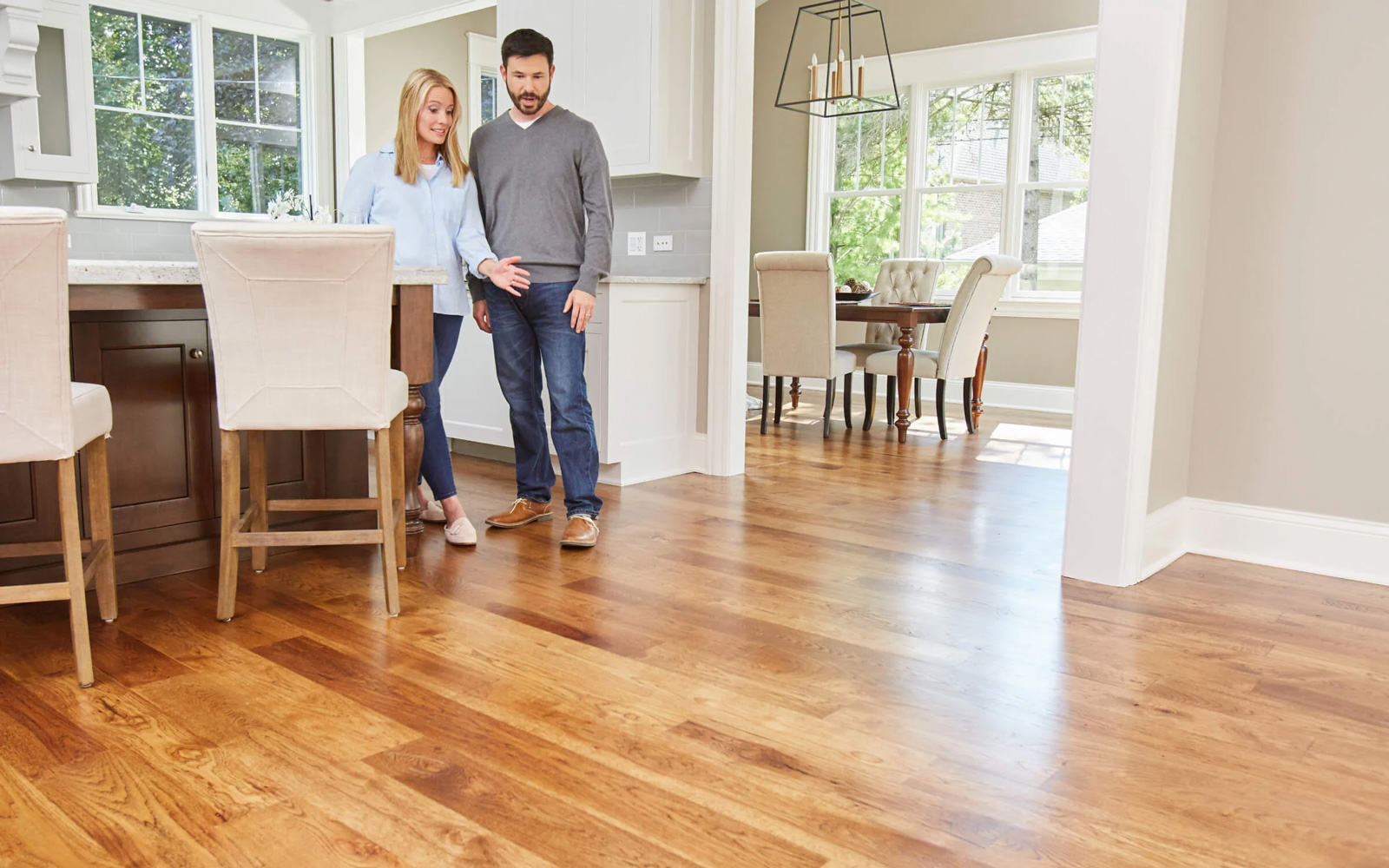Couple admiring newly installed hardwood floors