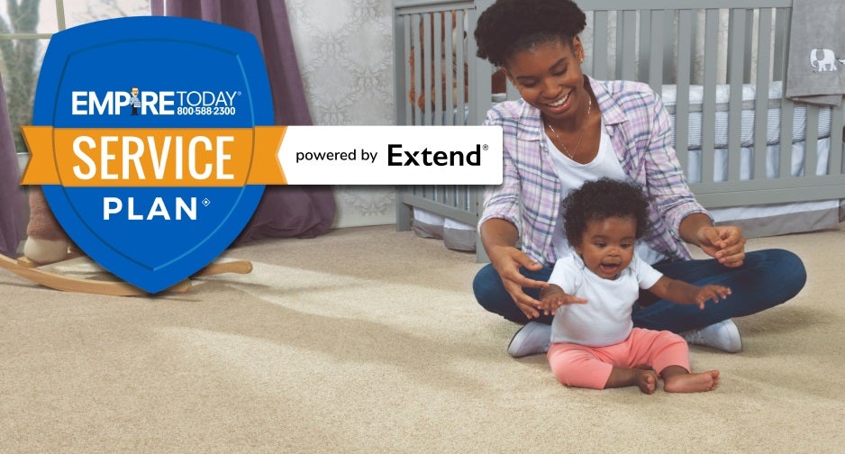 Image of happy mom and baby playing on carpet. 