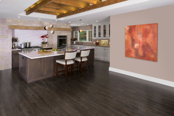 dark gray solid hardwood flooring in a kitchen and dining area