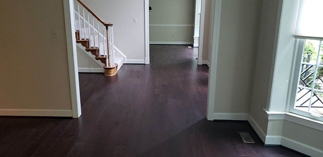 durable engineered hardwood flooring in the foyer and living room