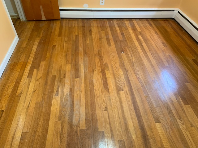 Before: hardwood flooring in the bedroom