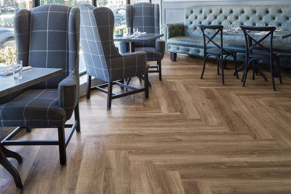 commercial vinyl plank in a restaurant with gray armchairs