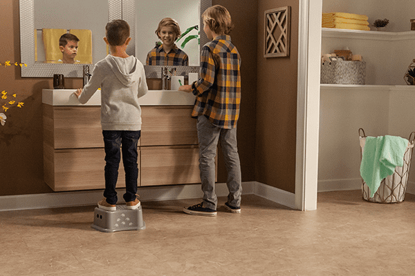 boys brushing teeth in a bathroom with vinyl tile flooring