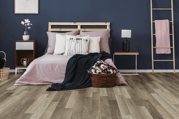 greige laminate wood flooring in a bedroom 