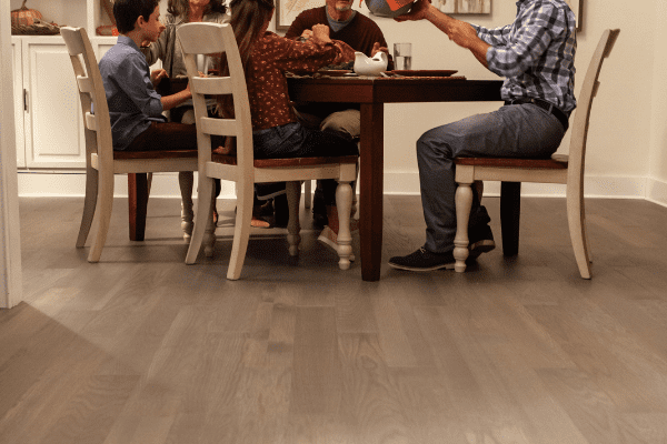 family having thanksgiving dinner at dining table with hardwood flooring 