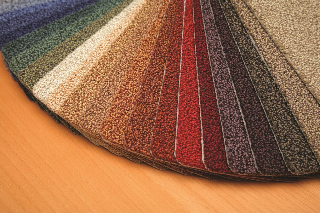 Fanned out swatches of carpet samples in a full rainbow of colors